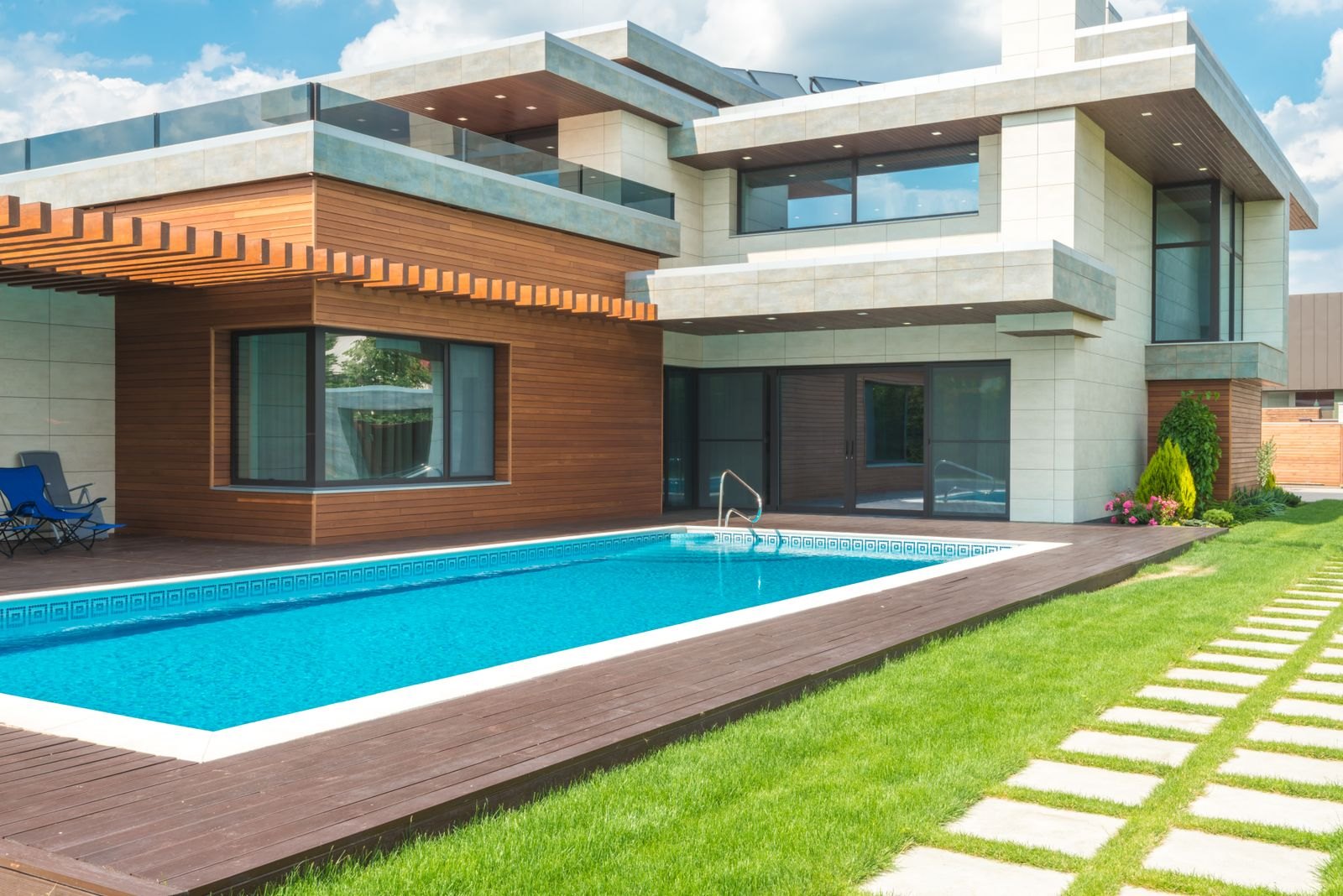 Modern home with a rectangular inground pool and wood deck
