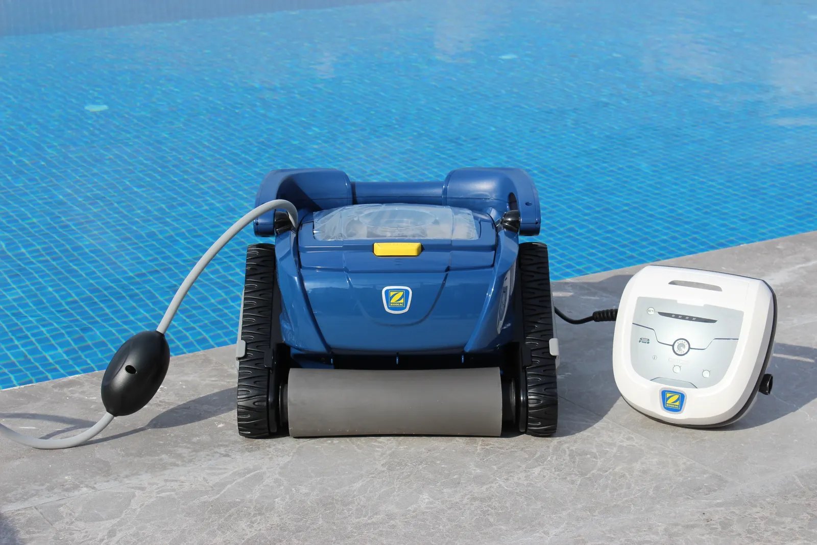 Robotic pool cleaner at the edge of a pool